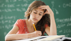 Lehi, Utah, USA --- Caucasian teenager studying in classroom --- Image by © Mike Kemp/Blend Images/Corbis